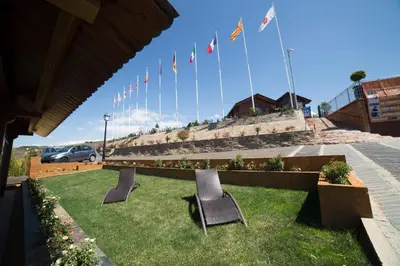 a row of flags and chairs in the grass at Hotel Albergue La Casa Del Peregrino in El Acebo de San Miguel