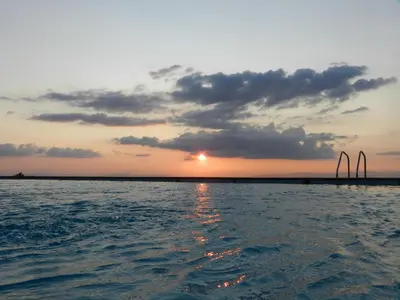 a sunset over a body of water with the sun setting at Hotel Albergue La Casa Del Peregrino in El Acebo de San Miguel