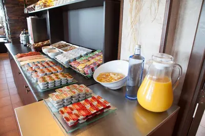 a buffet of food and a bottle of orange juice at Hotel Albergue La Casa Del Peregrino in El Acebo de San Miguel