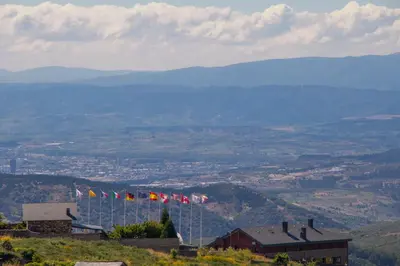 a group of flags flying on a mountain at Hotel Albergue La Casa Del Peregrino in El Acebo de San Miguel