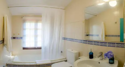 a bathroom with a sink and a toilet and a mirror at Casa rural Catro do Lugarexo in Villarmayor
