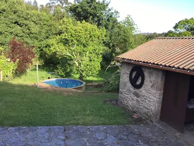 a stone building with a pool in a yard at Casa rural Catro do Lugarexo in Villarmayor