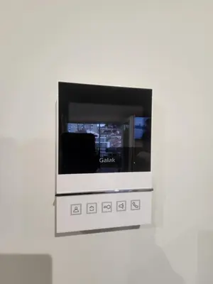 a television on a wall with a white wall at Calpurnia Abana in Ourense