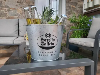 three bottles of beer in a bucket on a table at Calpurnia Abana in Ourense
