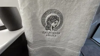 a towel with a logo on it sitting on a chair at Calpurnia Abana in Ourense