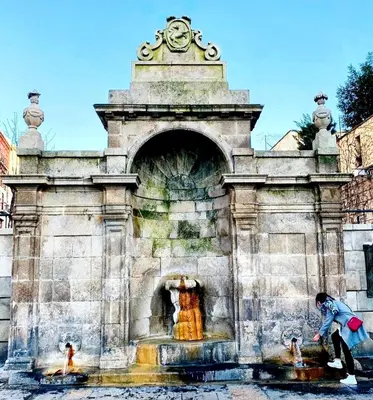 a man playing in a fountain in a park at Calpurnia Abana in Ourense