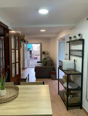 a living room with a couch and a table at A Casa do Sastre1 in Ribadavia