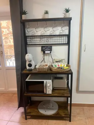 a shelf with a microwave on a table at A Casa do Sastre1 in Ribadavia