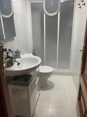 a white bathroom with a sink and a toilet at A Casa do Sastre1 in Ribadavia