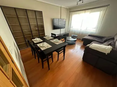 a living room with a table and a couch at Increíble dúplex en Lugo in Lugo
