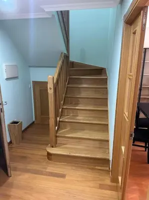 a staircase with wooden steps in a room at Increíble dúplex en Lugo in Lugo