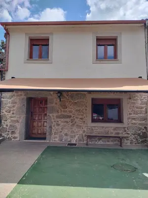 a house with a green lawn in front of it at Casa San Miguel in Chantada