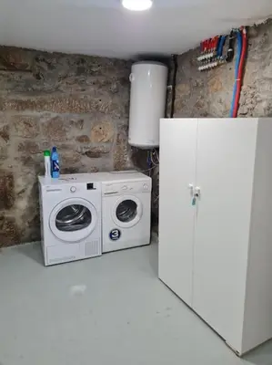a kitchen with a washing machine and a refrigerator at Casa San Miguel in Chantada