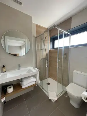 a white kitchen with a sink and a microwave at Apartamentos CRUNIA - Estudios in A Coruña