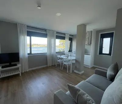 a bathroom with a shower and a sink and a toilet at Apartamentos CRUNIA - Estudios in A Coruña
