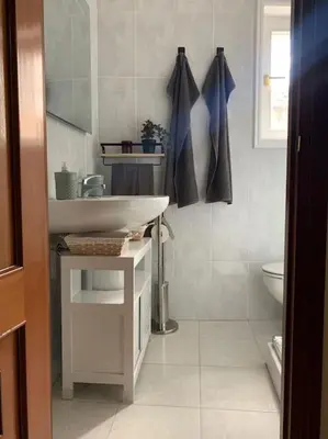 a white bathroom with a sink and a toilet at A Casa do Sastre 2 in Ribadavia