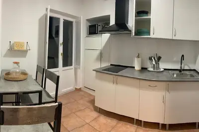 a kitchen with a sink and a table and a counter at A Casa do Sastre 2 in Ribadavia