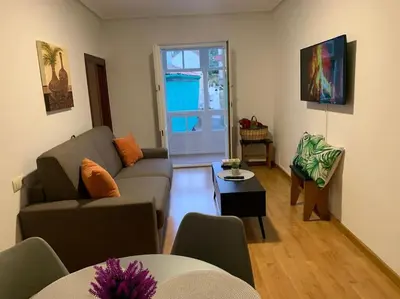 a living room with a couch and a table at A Casa do Sastre 2 in Ribadavia