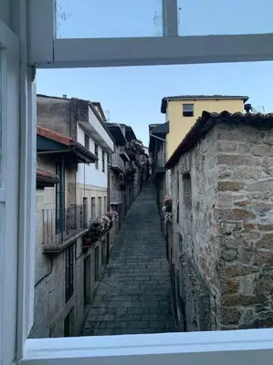 a view of an alley with a stone building at A Casa do Sastre 2 in Ribadavia