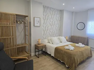 a bedroom with a bed with two towels on it at Lugo Apartamento nuevo en centro de la ciudad in Lugo