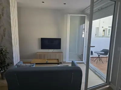 a living room with a couch and a tv at Lugo Apartamento nuevo en centro de la ciudad in Lugo