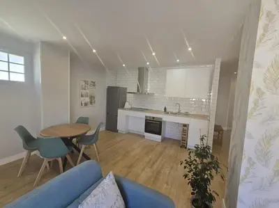 a living room with a blue couch and a table at Lugo Apartamento nuevo en centro de la ciudad in Lugo