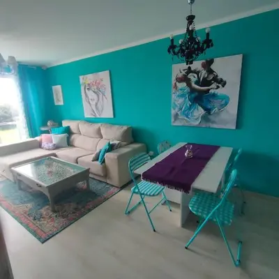 a living room with a couch and a table at Apartamento con piscina in Barreiros