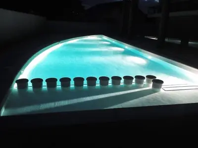 a swimming pool with a row of balls in it at Apartamento con piscina in Barreiros