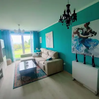 a living room with a couch and a table at Apartamento con piscina in Barreiros