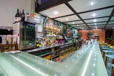 a bar with a lot of bottles of alcohol at Hotel Restaurante Pontiñas in Lalín