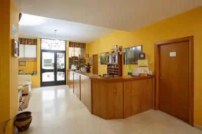 a room with yellow walls and a counter in a room at Hotel Restaurante Pontiñas in Lalín