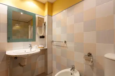 a bathroom with a sink and a toilet at Hotel Restaurante Pontiñas in Lalín