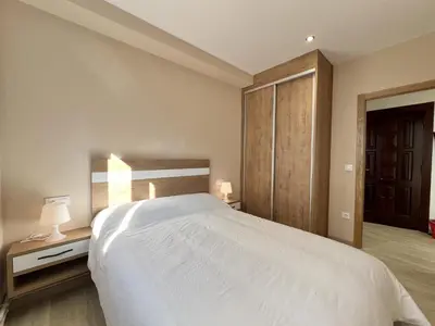 a bedroom with a large white bed and two lamps at Sea Horizon I in Sada