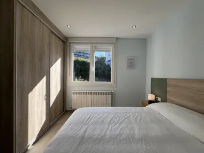 a bedroom with a large bed and a window at Sea Horizon I in Sada