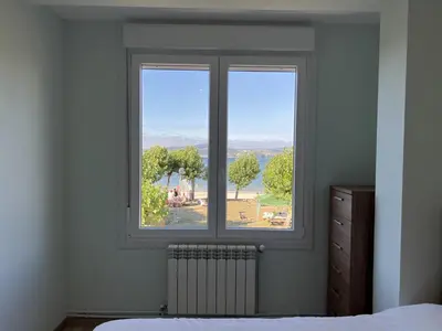 a bedroom with a window with a view at Sea Horizon I in Sada