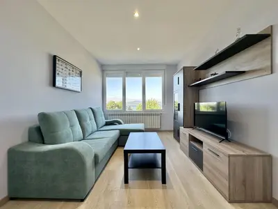 a living room with a couch and a flat screen tv at Sea Horizon I in Sada
