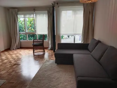 a living room with a couch and two windows at Fonteculler in Fonte Culler
