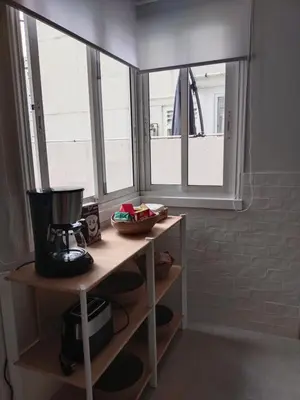 a kitchen with a coffee maker on a shelf next to a window at Fonteculler in Fonte Culler