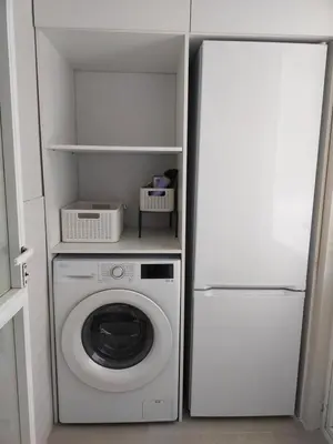 a washer and dryer in a kitchen next to a refrigerator at Fonteculler in Fonte Culler