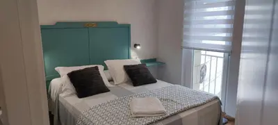 a bedroom with a large bed with a blue headboard at Vivienda de uso Turístico Casa As Cachopas in Palas de Rei