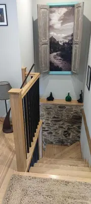 a staircase in a room with a painting on the wall at Vivienda de uso Turístico Casa As Cachopas in Palas de Rei