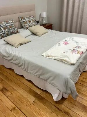 a bed with a blanket and pillows on it at Marujarural in Sober