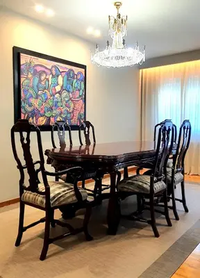 a dining room table and chairs with a painting on the wall at Marujarural in Sober