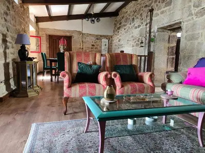a living room with two couches and a table at Xiravai-Ribeira Sacra in Peares
