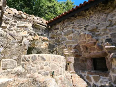 a stone building with a window on the side of it at Xiravai-Ribeira Sacra in Peares