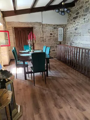 a dining room with a table and chairs at Xiravai-Ribeira Sacra in Peares