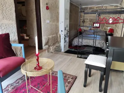 a living room with a table and a bed at Xiravai-Ribeira Sacra in Peares
