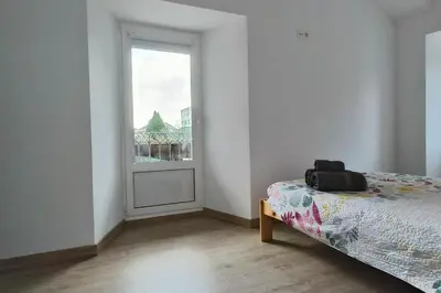 a white room with a bed and a window at Casa Sáner in Rábade