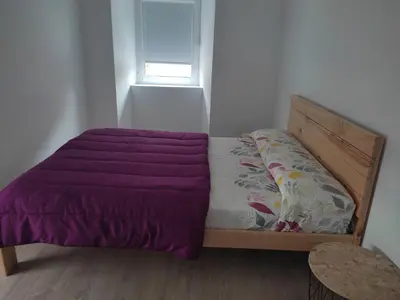 a bed with a purple comforter in a bedroom at Casa Sáner in Rábade