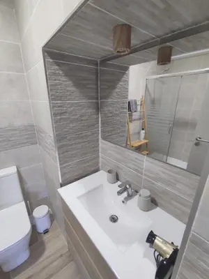 a bathroom with a sink and a toilet and a mirror at Casa Sáner in Rábade